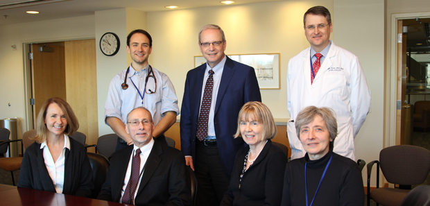 Dr. Robert Watcher (center standing), the Accreditation Council for Graduate Medical Education Clinical Learning Environment Review Committee and Graduate Medical Education Committee faculty and fellows