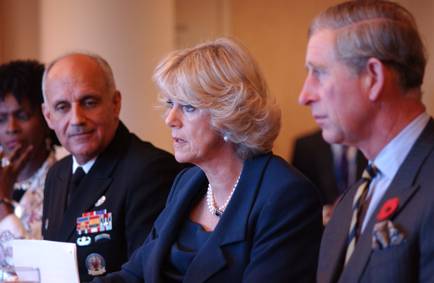 Camilla speaks to a group of osteoporosis researchers and leaders in the Clinical Center medical board room as Prince Charles, seated beside her, listens. Camilla’s interest in the medical condition, which afflicted her mother and grandmother, prompted the royal couple’s visit to NIH as a part of their eight-day US tour.