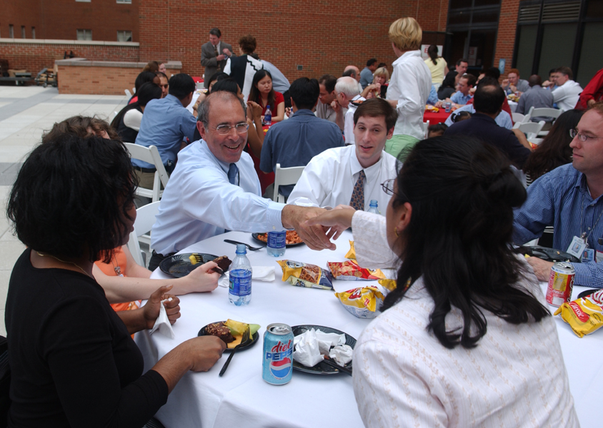Picture of Dr. John I. Gallin, Clinical Center director, greeting one of NIH’s
     80 new clinical fellows at the July 6 reception
