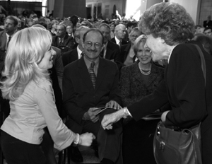 Photo of patient Brianne Schwantes chatting with NIH dignitaries