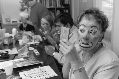 Photo of NIH student clowns applying their makeup