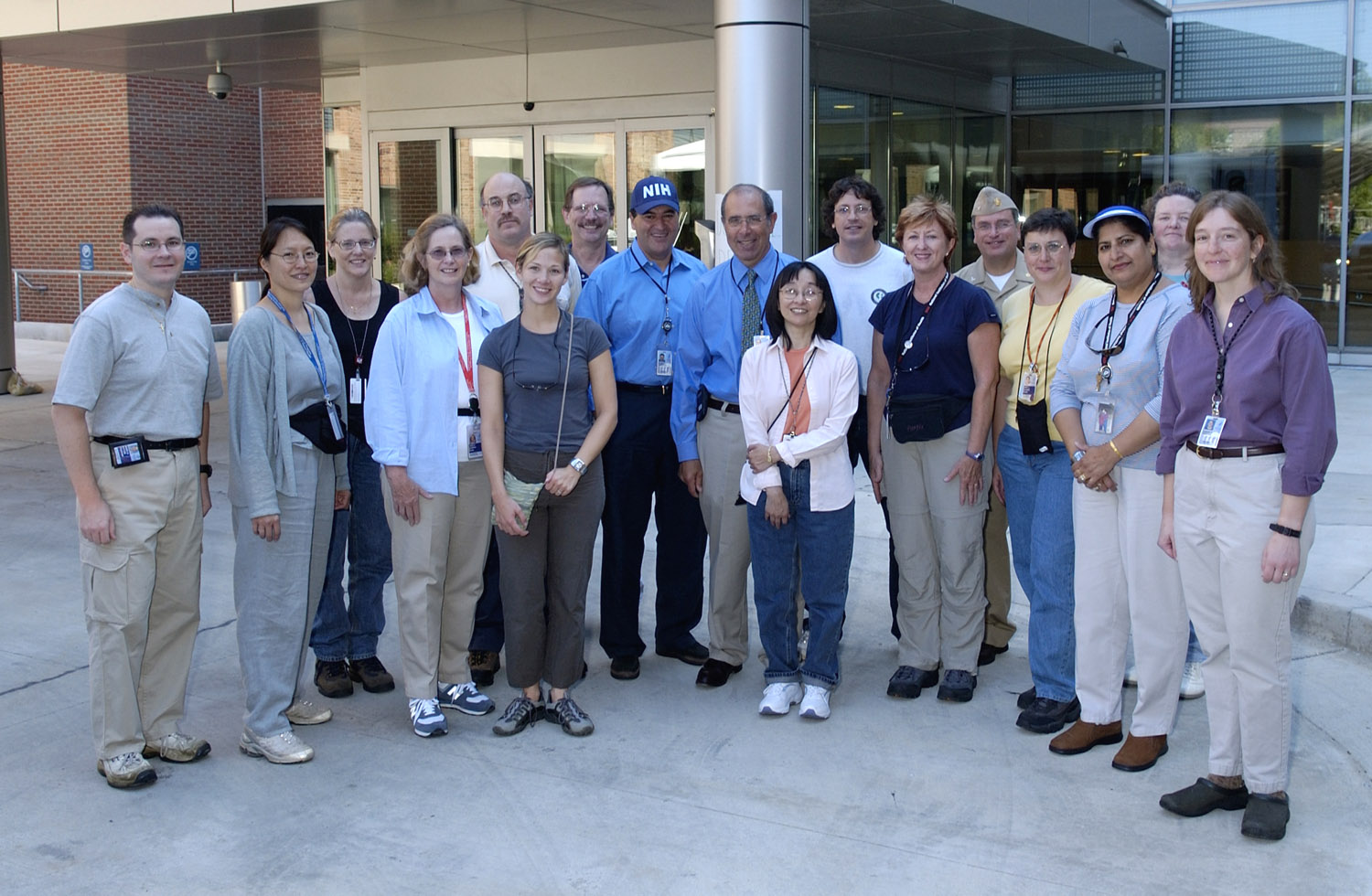 NIH director Dr. Elias Zerhouni (center in ballcap) and CC director Dr. John Gallin (on the director?s left) meet with NIH volunteers who were deployed Sept. 4. They include (from l) Mark Ritter, Maryland Pao, Melanie Bacon, Jean Murphy, Mike Polis, Amy Garner-O?Brien, Jim Shelhamer, Alice Pao, James Gibbs, Deb Gardner, Bob Danner, Mary Sparks, Sashi Ravindran, Grace Kelly and Susan Hoover.