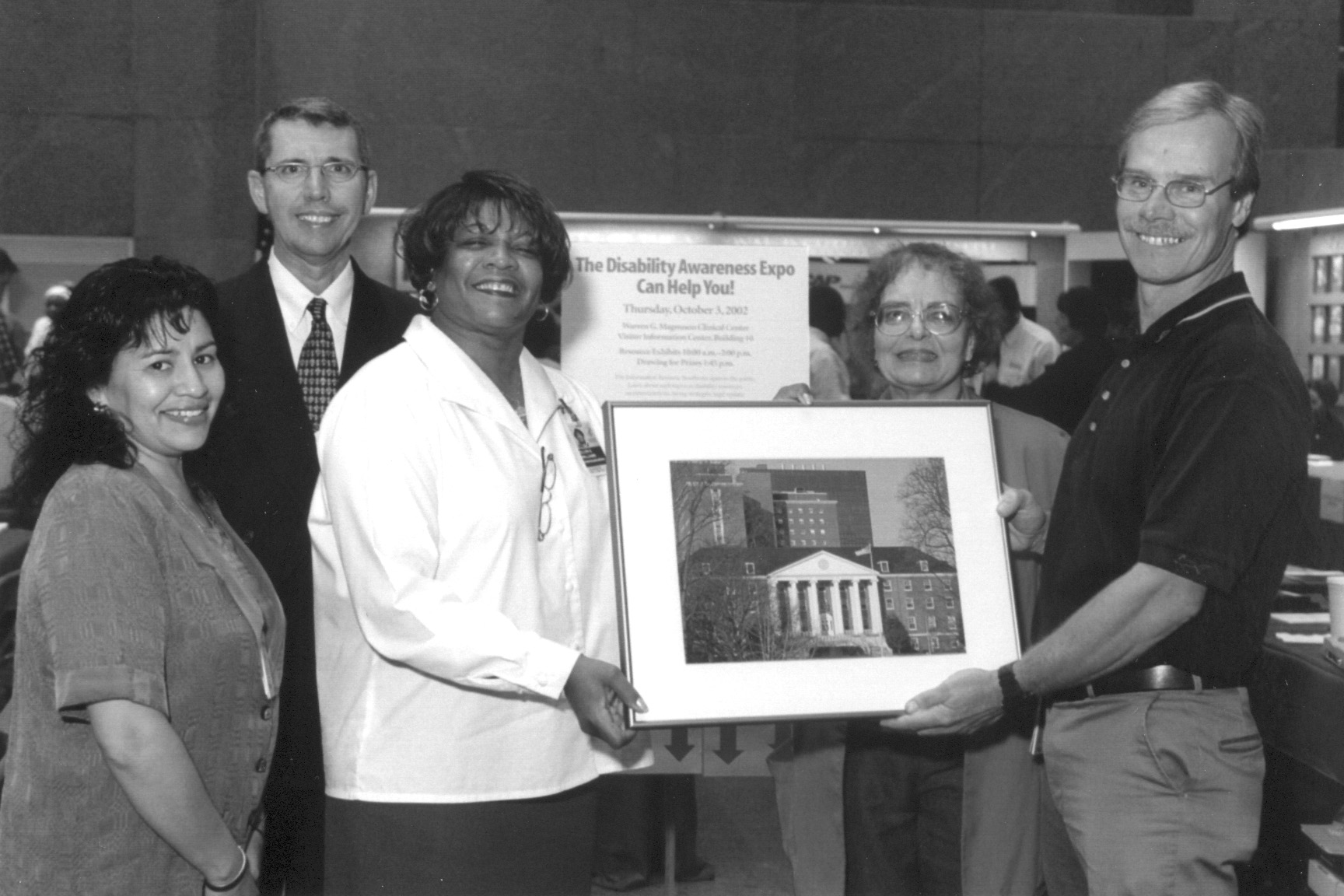 Photo of Robert Ennis being presented with a framed photo of NIH