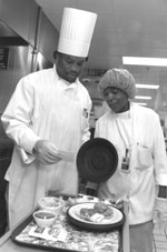 Photo of Rene Brown and Catherine Worrell inspecting a patient dinner tray