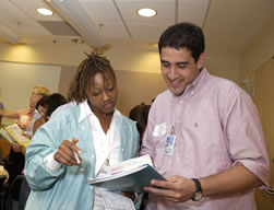  Anita Thomas and Jason Saysanlar, both new to the Clinical Center, participate in a cultural communication exercise as part of the CC's new orientation program.