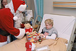 Photo of boy receiving gifts from Santa