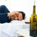 man with a headache from drinking wine