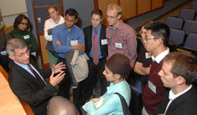NIAID Director Dr. Anthony Fauci talks with students after his keynote presentation at the CIST forum.
