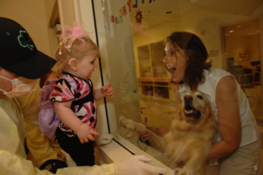 A pet therapy volunteer visits Katlyn and her family.