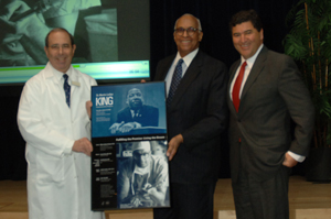 CC Director and NIH Director present poster to doctor.