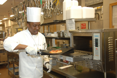 Cooking a pizza in the Nutrition Department's new high-speed oven.