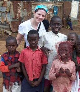 ICU Nurse Heather Rhine stands with children she encountered on a medical mission to Kenya.