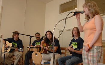 Staffers and patients join together to perform Landslide at a pizza party on July 29.