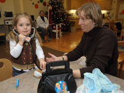 Recreation Therapy chief Donna Gregory plays with Sydnie Gapper.