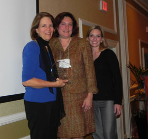 Dr Hastings receives award from two IACRN representatives