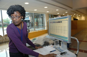 nurse looks at patient id system console