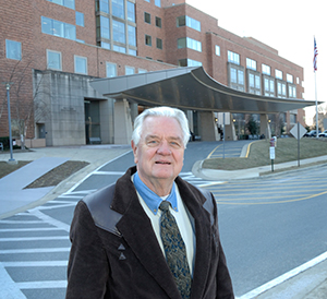 Jim Wilson standing in front of the Clinical Center