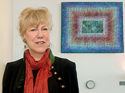Carol Brown Goldberg and the painting she donated