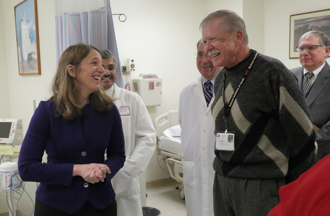 Sylvia M. Burwell speaking with patient Don Dean in the Clinical Center