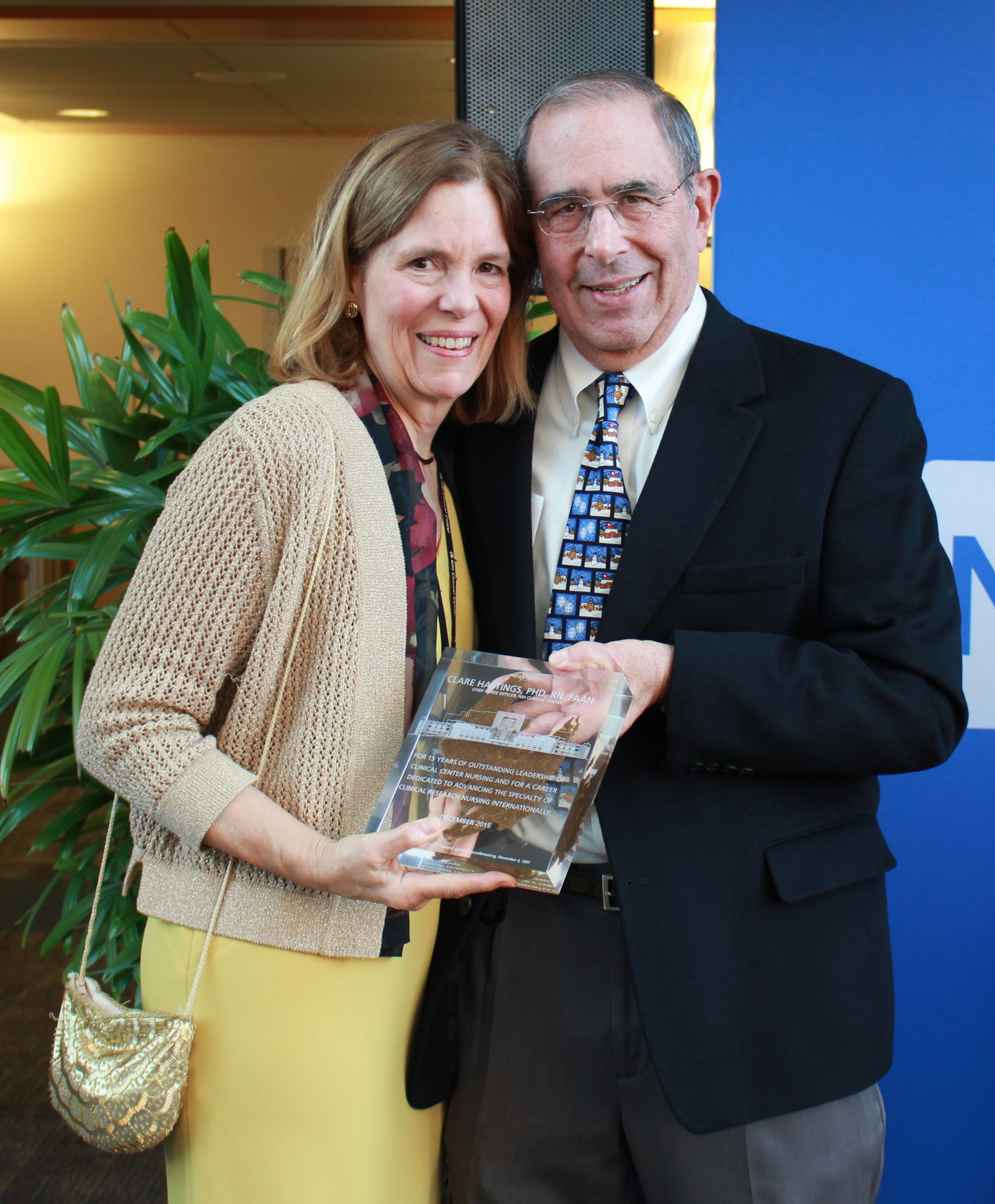 Dr. John I. Gallin presents Dr. Clare Hastings with the 'dirt award' at her retirement gathering.