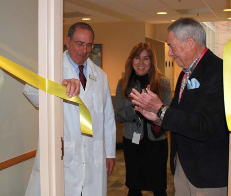 Dr. John I. Gallin, Heidi Grolig and a patient cut the ribbon.