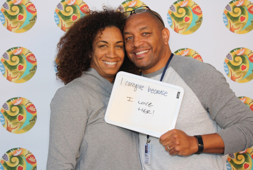 Candace Campbell, who's participating in a clinical trial at the CC, and her husband and caregiver Eric Campbell, pose in the caregiver day photo booth.