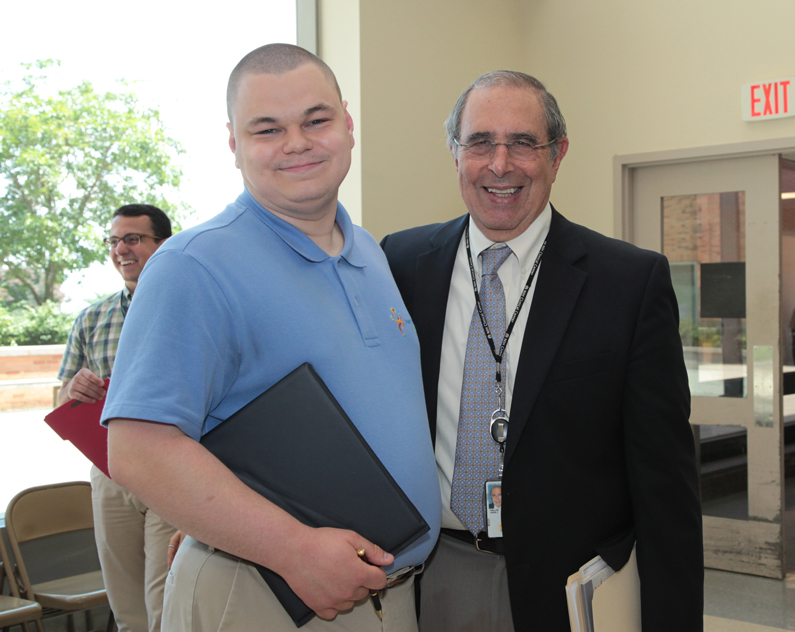 Project Search graduate Zachary Sweet and Dr. John I. Gallin at the graduation ceremony