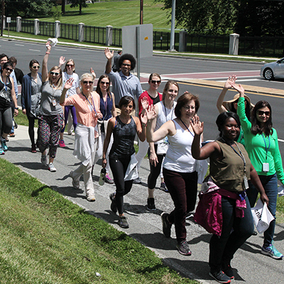 NIH staff wave at the camera on NIH Take a Hike day