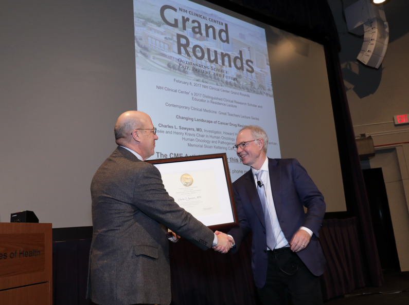Dr. James K. Gilman presenting a certificate of appreciation to Dr. Charles L. Sawyers