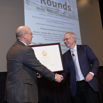Dr. James K. Gilman presenting a certificate of appreciation to Dr. Charles L. Sawyers