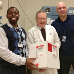 Three Department of Transfusion Medicine staff members receive a package of rare blood from Germany