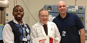 Three Department of Transfusion Medicine staff members receive a package of rare blood from Germany.