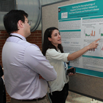 Trainee presents poster to colleagues