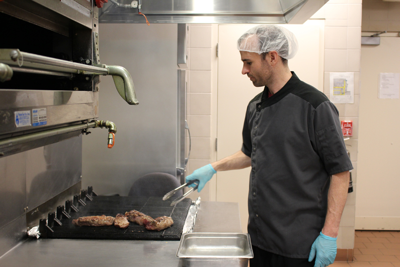 Jeff Tait, with the Nutrition Department, grills steaks for patients at the NIH Clinical Center Sept. 30.