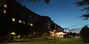 Exterior view of the north entrance of the NIH Clinical Center. Continuous coordination and open communication allow employees to focus on the mission at all hours.