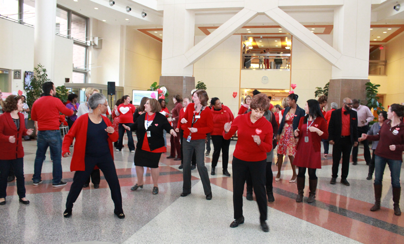 NIH staff and volunteers participate at the Clinical Center line dancing event to raise heart health awareness