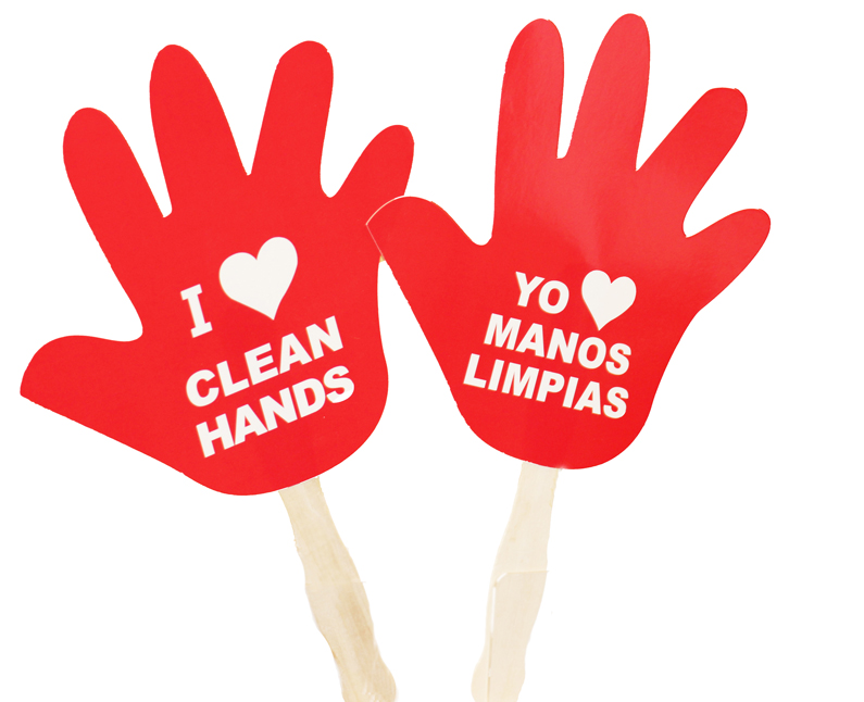 A paper cutout of a hand shape with a stick on the end. Text on the paper says I [heart] clean hands