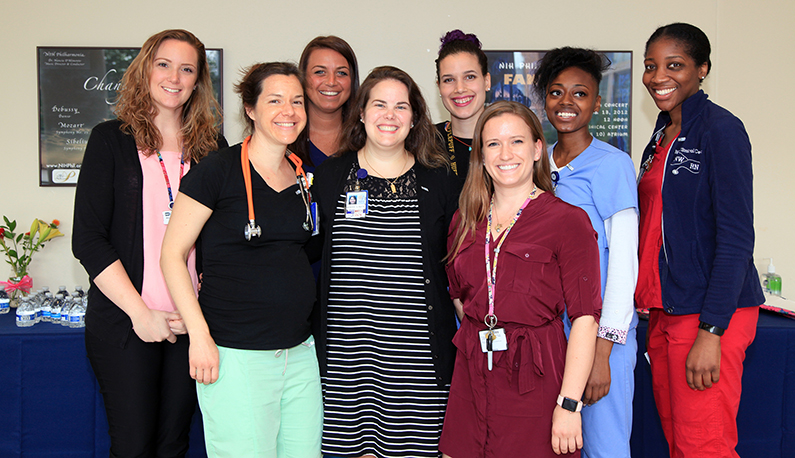 Eight female Clinical Research Nursing Residency Program representatives gather for a photo