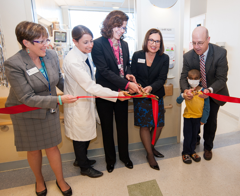 Barbara Jordan, Krista Cato, Dr. Zena Quezado, Dr. Deborah Merke, pediatric patient Hadi and Dr. James Gilman cutting the ribbon
