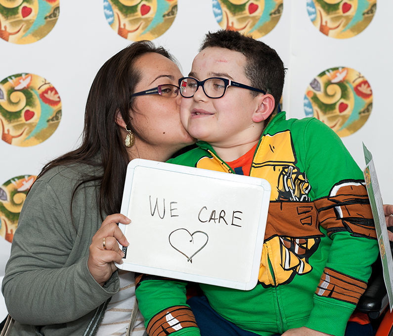Patient with caregivers participate in 2017 Caregiver Day photo booth