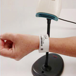 a patient's wristband getting scanned upon checking in or out