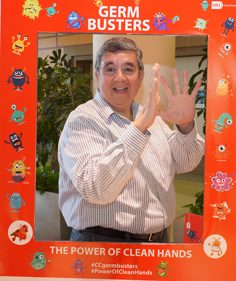 A man holding a Hand Hygiene I Love Clean Hands sign
