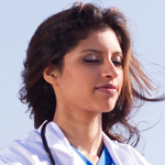A women in lab coat meditates in a serene environment