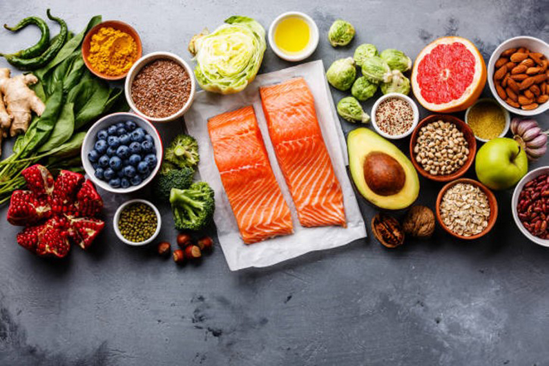 a table spread with salmon and other healthy foods