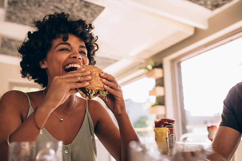 a woman eating a burger