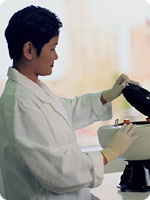 Photo of a laboratory technician working at a laboratory maching.