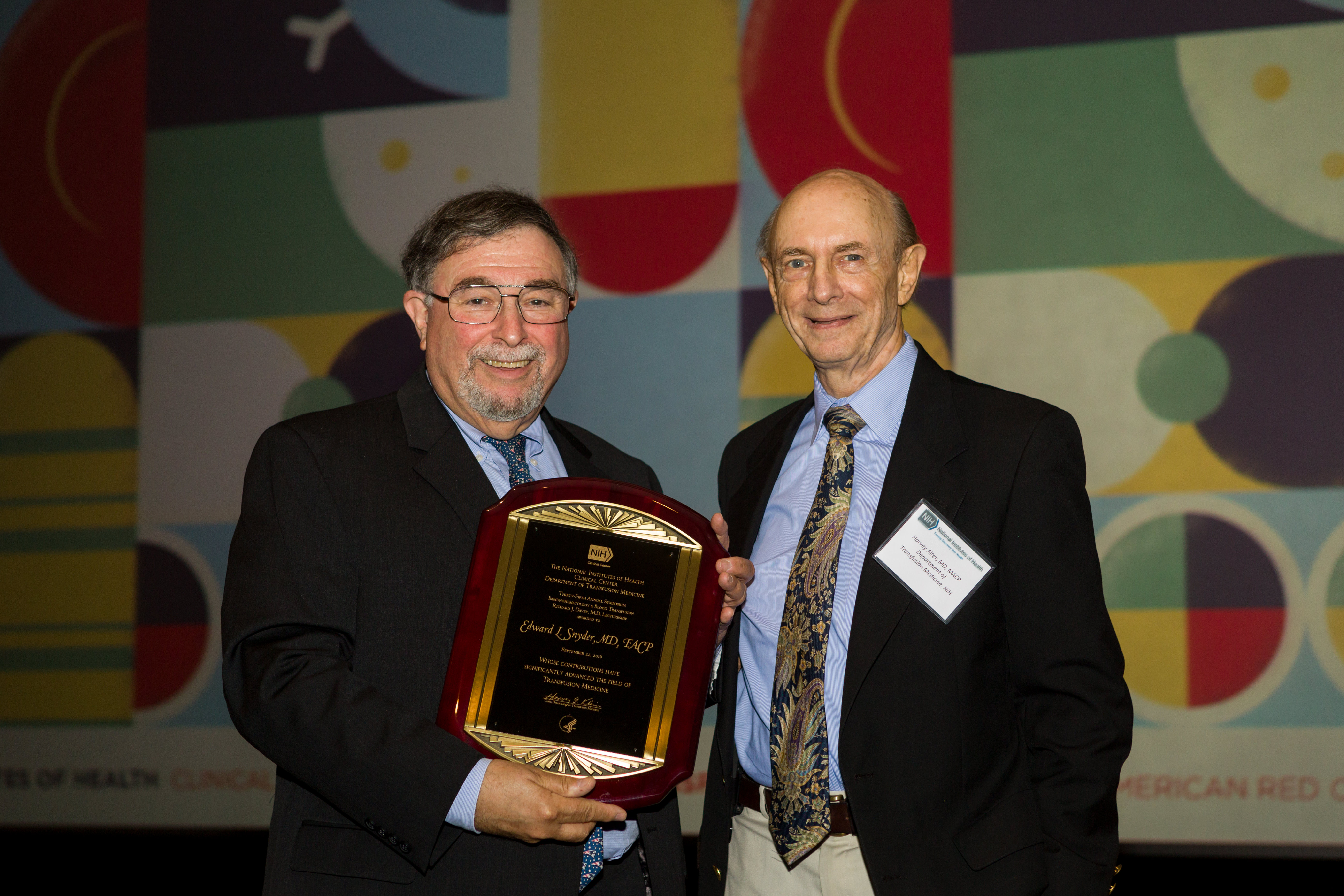 Dr. Harvey J. Alter of the NIH Clinical Center Department of Transfusion Medicine presents the Richard J. Davey Award to Dr. Edward L. Snyder of Yale-New Haven Hospital.