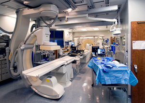 OR view of a rotational angiography in the foreground and CT-based tools in the background.