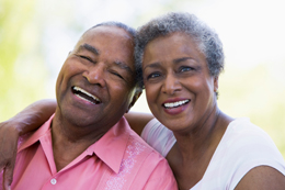 two elderly people smiling