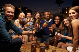 A group of people drinking alcoholic beverages at a party